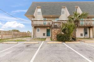 a house with a parking lot in front of it at Islandwood in Fort Walton Beach