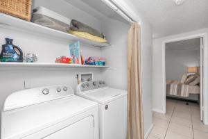 a white laundry room with a washer and dryer at Islandwood in Fort Walton Beach +28 photos