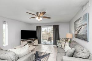 a living room with a couch and a flat screen tv at Islandwood in Fort Walton Beach