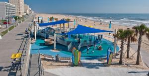a water park on the beach with people on the beach at Oceanfront Beach Condo, Pool, Gym, Fishing Surfing in Virginia Beach