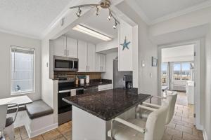 a kitchen and dining room with a table and chairs at New / Oceanfront Beach Condo, Pool, Gym, Fishing in Virginia Beach