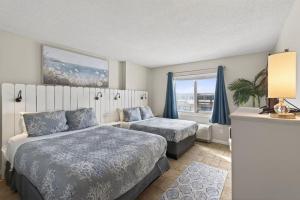 a bedroom with two beds and a window at New / Oceanfront Beach Condo, Pool, Gym, Fishing in Virginia Beach +43 photos