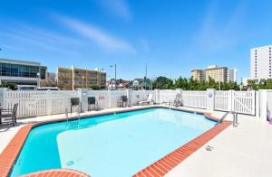a swimming pool on the roof of a building at Oceanfront Condo/ Pool/ Surfing/ Fishing / EW 1002 in Virginia Beach