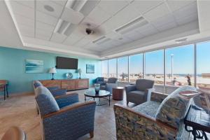 a living room with couches and chairs and a television at Oceanfront Condo, Heated Pool, Fitness Center in Virginia Beach