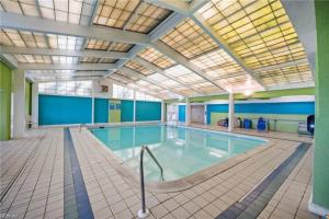 a large indoor swimming pool with a large pool at Oceanfront Condo, Heated Pool, Fitness Center in Virginia Beach