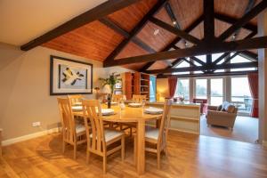 a dining room and living room with a table and chairs at Underscar - Luxury 3 Bed Apartment in Applethwaite