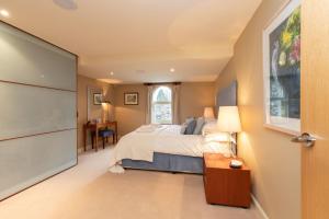 a bedroom with a bed and a desk and a window at Underscar - Luxury 3 Bed Apartment in Applethwaite +24 photos