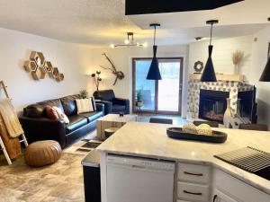 a living room with a couch and a fireplace at The Wanderlust at the Sunset Cove in Wisconsin Dells