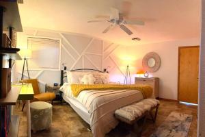 a bedroom with a bed with a ceiling fan at The Wanderlust at the Sunset Cove in Wisconsin Dells +36 photos