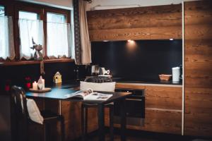 a kitchen with a table and a stove and a television at Maison Carrel Elegant 8 in Breuil-Cervinia