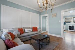 a living room with a couch and a table at The Anchor Once Upon A Tide Villas POOL in Bay Saint Louis