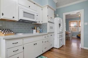 a kitchen with white cabinets and a white refrigerator at The Anchor Once Upon A Tide Villas POOL in Bay Saint Louis +63 photos