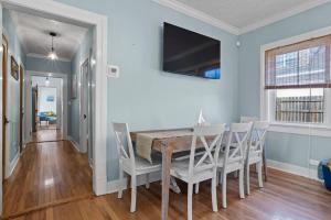 a dining room with a table and chairs at The Anchor Once Upon A Tide Villas POOL in Bay Saint Louis