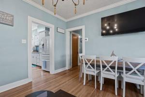 a kitchen and dining room with a table and chairs at The Anchor Once Upon A Tide Villas POOL in Bay Saint Louis