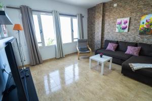 a living room with a couch and a table at Edificio Prieto Vivienda 2D in Puerto del Rosario