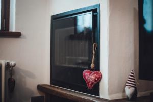 a red heart ornament hanging from a tv at Maison Carrel Elegant 8 in Breuil-Cervinia