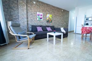 a living room with a couch and a table at Edificio Prieto Vivienda 2D in Puerto del Rosario