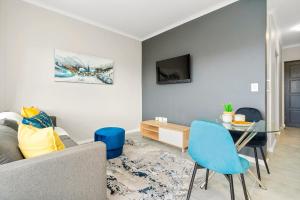 a living room with a couch and a table at The Orion 16 in Table View