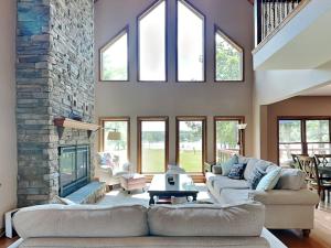 a living room with two couches and a stone fireplace at Paravel in Swanton