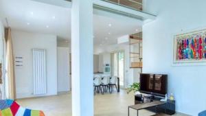 a living room and dining room with a tv and a living room at Villa Laura in Cefalù