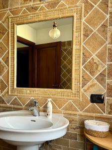 a bathroom with a sink and a mirror at Casa dei nonni in Rigali +12 photos