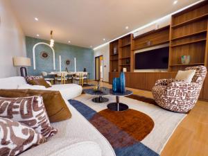 a living room with a couch and a tv at Résidence LOBOS by Ilios in Dakar