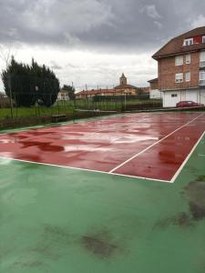 a tennis court with water on top of it at Apartamento La Ojerada in Ajo