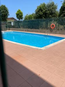 a large blue swimming pool in a yard at Apartamento La Ojerada in Ajo