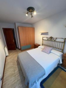 a bedroom with a large bed and a ceiling fan at Apartamento La Ojerada in Ajo +18 photos