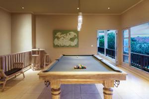 a pool table in the middle of a room at Puri Temple Villa in Canggu