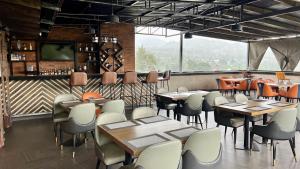 a restaurant with tables and chairs and a bar at Iwandaa Boutique Hotel in Nkoanrua