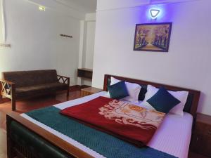 a bedroom with a bed with a red blanket at Rose Cottage in Devikolam
