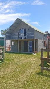 a house with a fence in front of it at Apartamento La Balsa in San Gregorio de Polanco