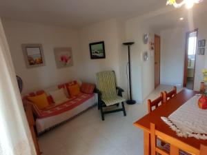 a living room with a couch and a table at Les Motes Solo Familias Serviplaya!!! in Playa de Xeraco +83 photos