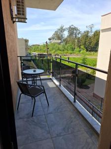 a patio with a table and chairs on a balcony at Torgai Hotel Apartments in Ureki