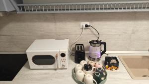 a microwave sitting on a counter next to a coffee maker at Ultracentral Piata in Caracal