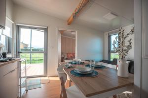a kitchen and living room with a wooden table with chairs at Balea House in Barreiros +15 photos