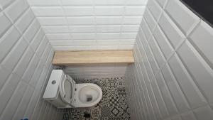 a small bathroom with a toilet and a sink at Ultracentral Piata in Caracal +11 photos