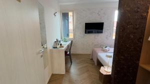 a bathroom with a sink and a bed in a room at Cà De La Corona EXPERIENCE in Chioggia +18 photos