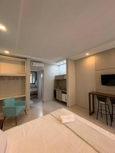 a bedroom with a bed and a desk and a table at Pousada São Gerônimo in Matinhos +119 photos