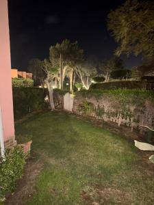 a yard at night with a fence and trees at باليمرا in Ain Sokhna