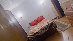 a bedroom with a bed with a pillow on it at باليمرا in Ain Sokhna