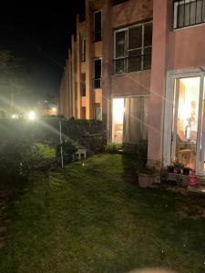 a yard of a house at night with lights at باليمرا in Ain Sokhna +1 photo