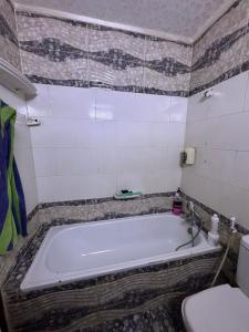a bathroom with a bath tub and a toilet at باليمرا in Ain Sokhna