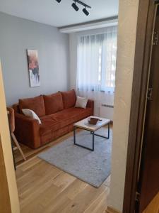 a living room with a couch and a coffee table at Aria lux Titova vila in Zlatibor