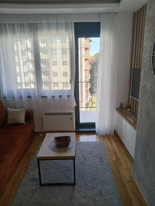 a living room with a couch and a coffee table at Aria lux Titova vila in Zlatibor
