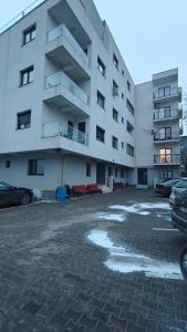 a large building with snow on the ground in front of it at Ultracentral Piata in Caracal