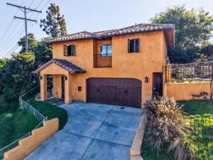 a house with a garage and a driveway at The Little Pumpkin Guest House in San Diego