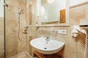 a bathroom with a sink and a shower at Jausenstation Pfefferbauer in Zell am See