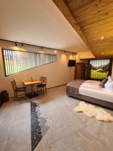 a bedroom with a bed and a table in a room at Wellness Chalet Apartment Hochkalter in Bischofswiesen